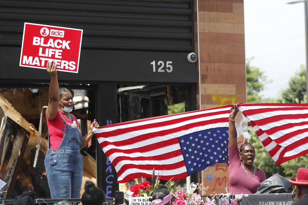 Protesters chant outside a Wendy's restaurant on Tuesday, June 23, 2020, in Atlanta after a funeral for Rayshard Brooks was held. Brooks died after being fatally shot by an Atlanta police officer.