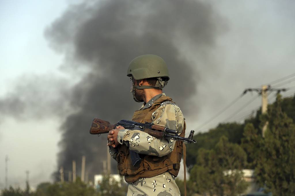 Smoke rises as angry Kabul residents set fire to part of the Green Village compound that has been attacked frequently, a day after a Taliban suicide attack in Kabul, Tuesday, Sept. 3, 2019.