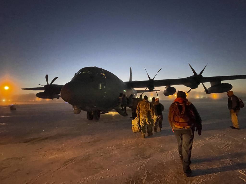 Helpers in the Alaska National Guard's Operation Santa Claus board a cargo plane at Joint Base Elmendorf-Anchorage on Tuesday, Nov. 29, 2022, for a flight to Nuiqsut, Alaska.