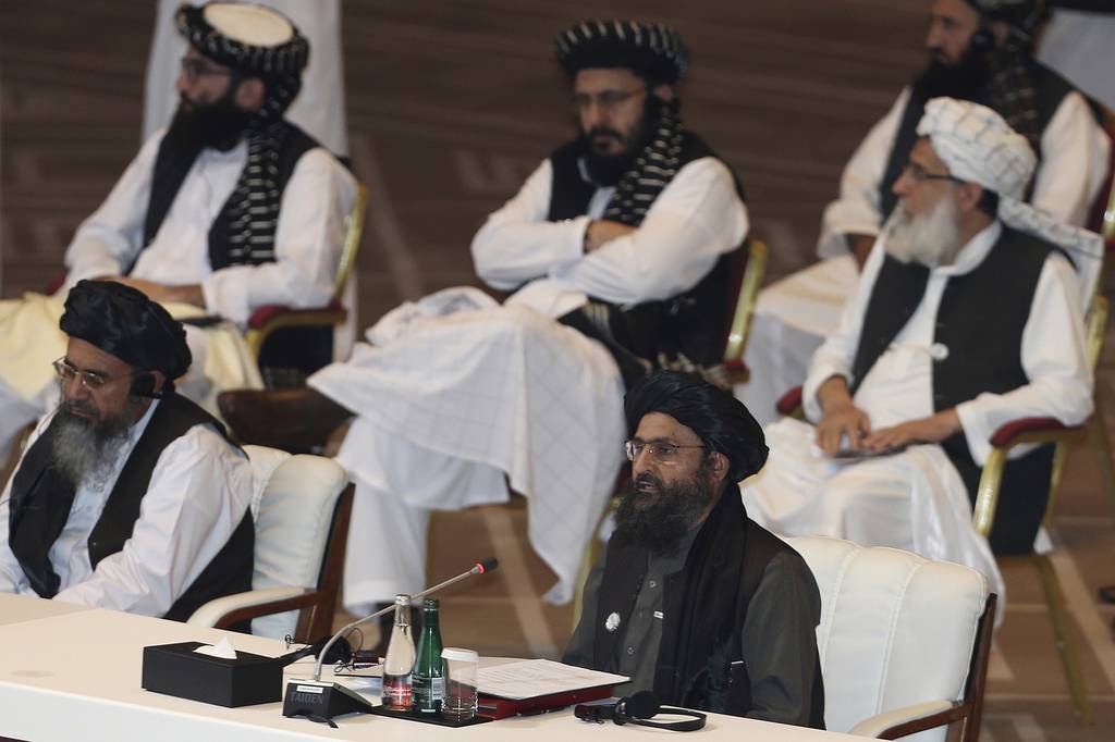 In this Sept. 12, 2020, file photo, Taliban co-founder Mullah Abdul Ghani Baradar, bottom right, speaks at the opening session of peace talks between the Afghan government and the Taliban in Doha, Qatar.