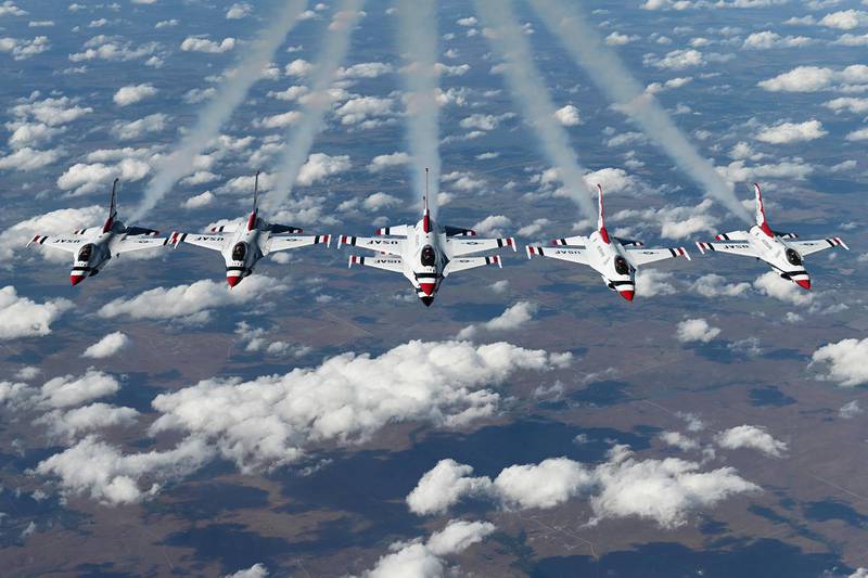 The U.S. Air Force Thunderbirds perform a six-ship formation under a KC-10 Extender, Oct. 22, 2020, over Oklahoma.