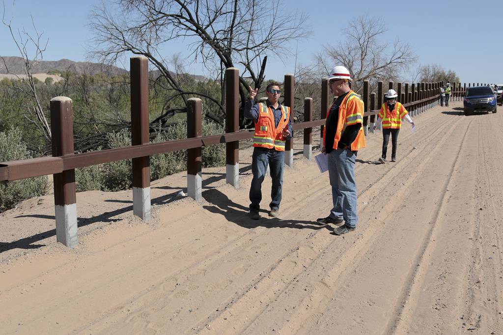 A team from the U.S. Army Corps of Engineers and contractors discuss Customs and Border Protection pedestrian border wall fencing requirements outside Yuma, Ariz., on April 11, 2019.