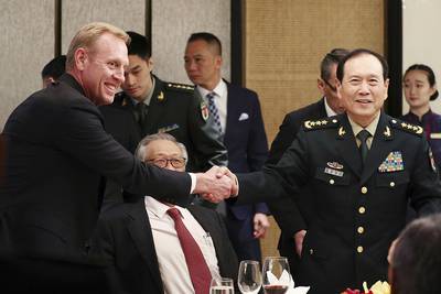 acting U.S. Secretary of Defense Patrick Shanahan, left, shakes hands with Chinese Minister of National Defense Gen. Wei Fenghe