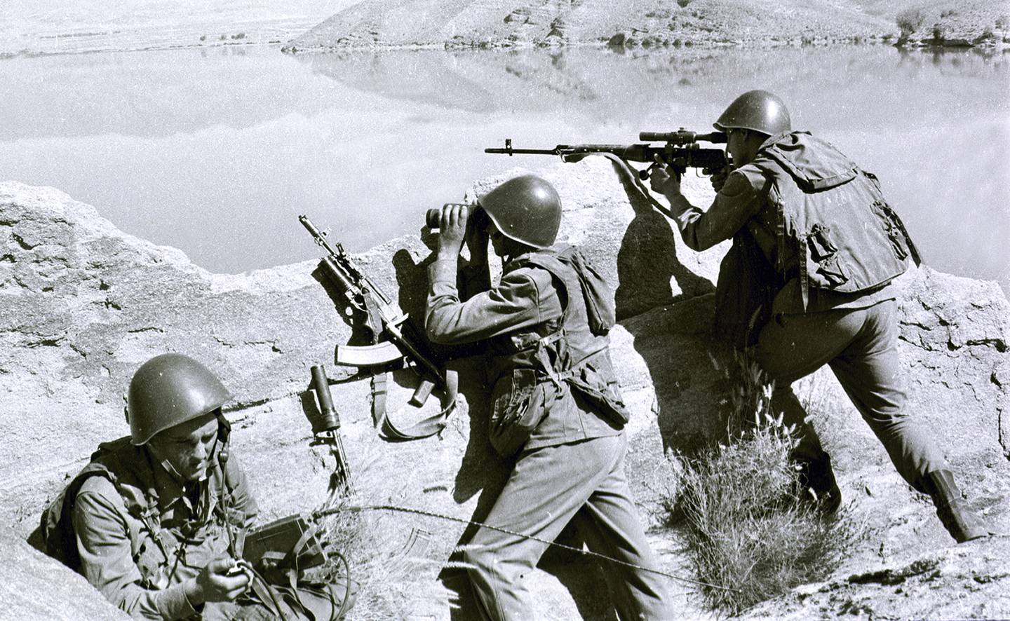 In this April 1988 file photo, Soviet soldiers observe the highlands while fighting Islamic guerrillas at an undisclosed location in Afghanistan.