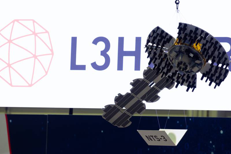 L3Harris Technologies slings a model of the Navigation Technology Satellite-3, or NTS-3, from the ceiling at the Sea-Air-Space conference in National Harbor, Maryland, in April 2023.