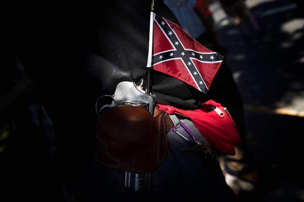 A man carrying a sidearm and Confederate flag attends a protest held by the Tennessee based group "New Confederate State of America" Sept. 16, 2017, in Richmond, Va.
