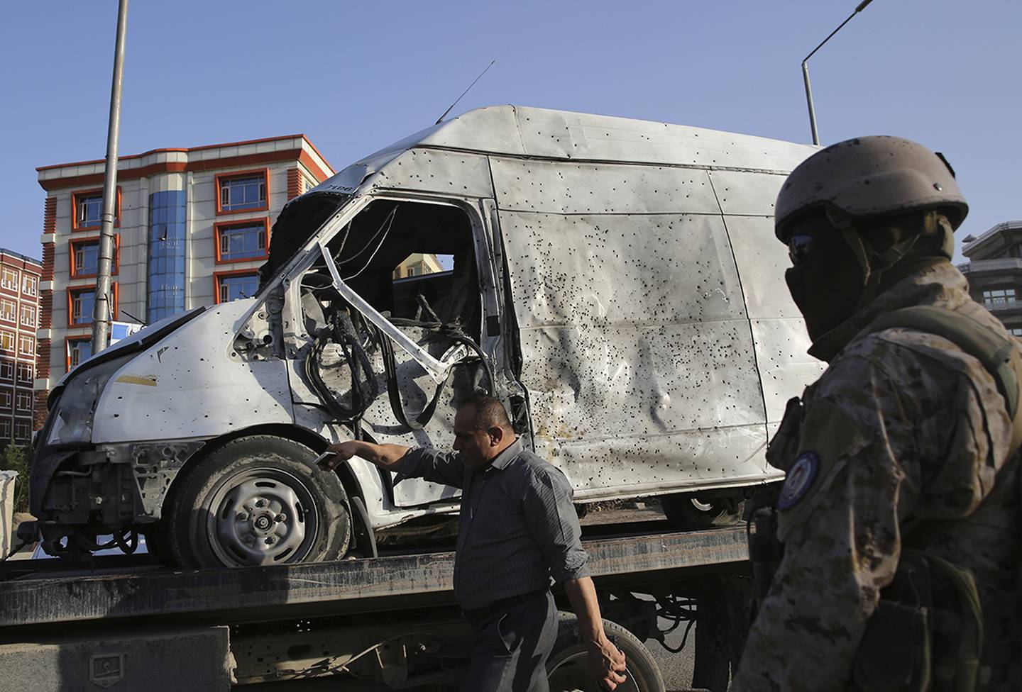 A damaged vehicle is removed from the site of a deadly explosion in Kabul, Afghanistan, Tuesday, Aug. 6, 2019.