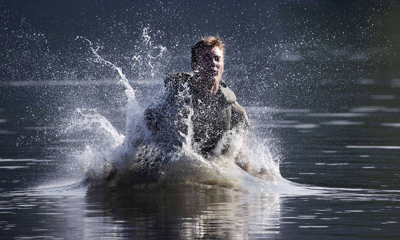 Farrell Thomas, of Lake Forest, Ill., splashes into a lake as he successfully completes a jump in a water obstacle course, Friday, Aug. 7, 2020, in West Point, N.Y.