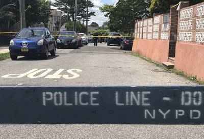 Crime scene tape cordons off an area in the South Beach section of the Staten Island borough of New York after a woman and two small children were found dead in a neighborhood home.