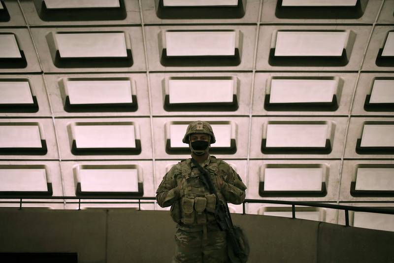 Soldiers from the North Carolina Army National Guard patrol the Rosslyn Metro station on the morning of the inauguration on Jan. 20, 2021, in Arlington, Va.