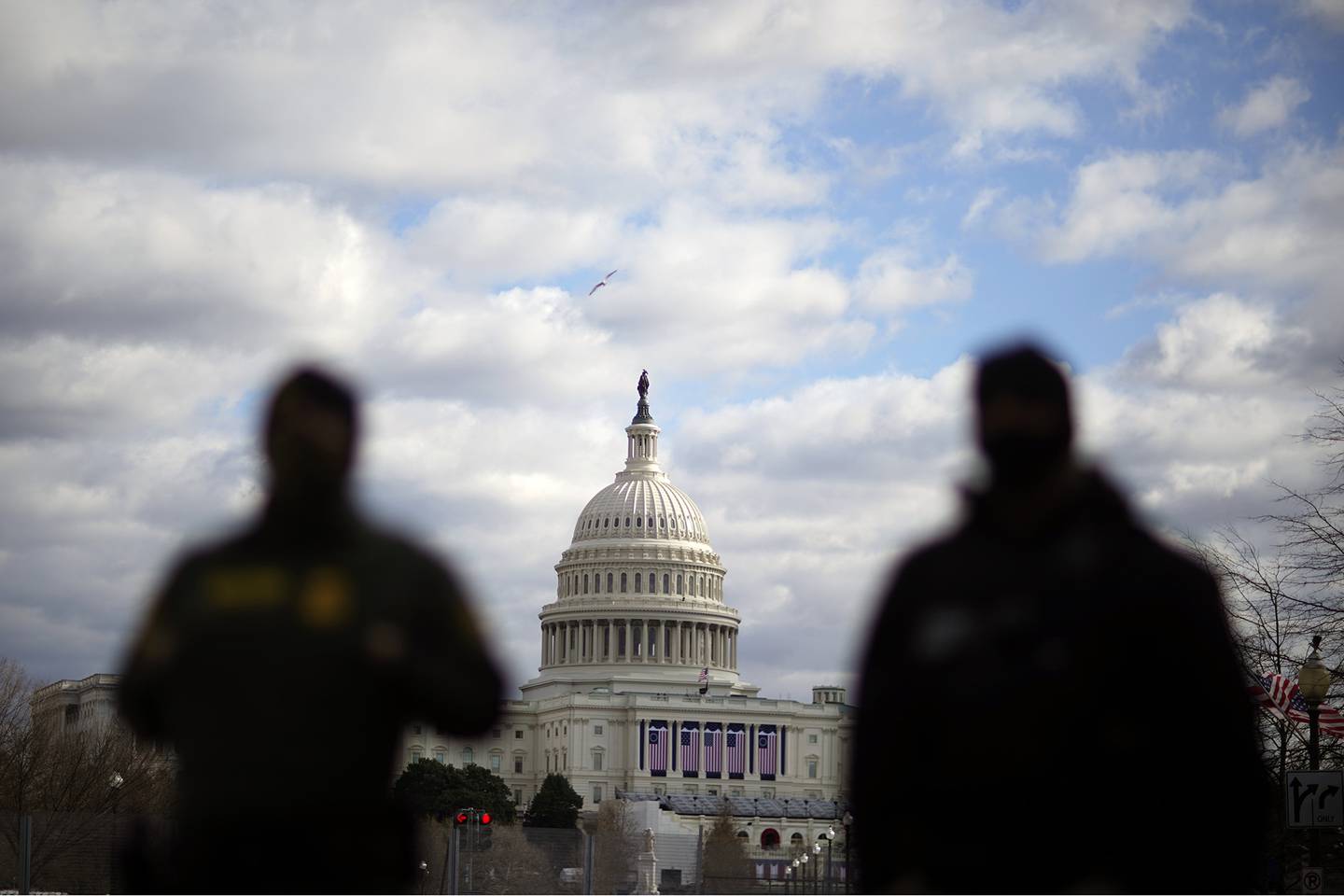 Law enforcement stand near the Capitol ahead of the inauguration of President-elect Joe Biden and Vice President-elect Kamala Harris, Sunday, Jan. 17, 2021, in Washington.