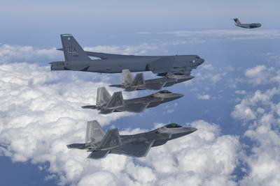 In this photo provided by South Korean Defense Ministry, A U.S. B-52 bomber, C-17 and South Korean Air Force F-35 fighter jets fly over the Korean Peninsula during a joint air drill in South Korea, Tuesday, Dec. 20, 2022.