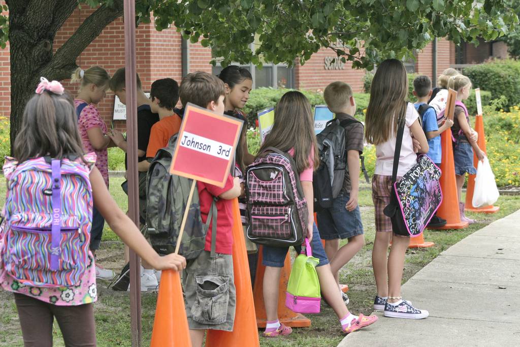 Students at Fort Bragg's Bowley Elementary School line up by class in the front of the school as they wait for their parents to pick them up after the first day of school in 2008.