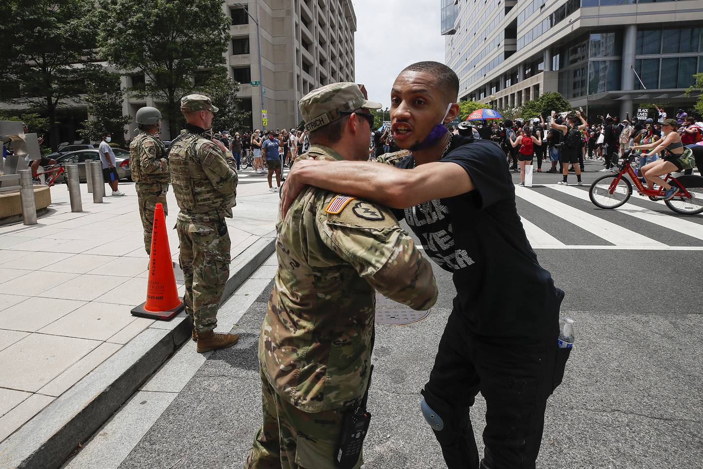 In this June 6, 2020, file photo, a demonstrator hugs a National Guard soldier during a protest  in Washington, over the death of George Floyd, a black man who was in police custody in Minneapolis.