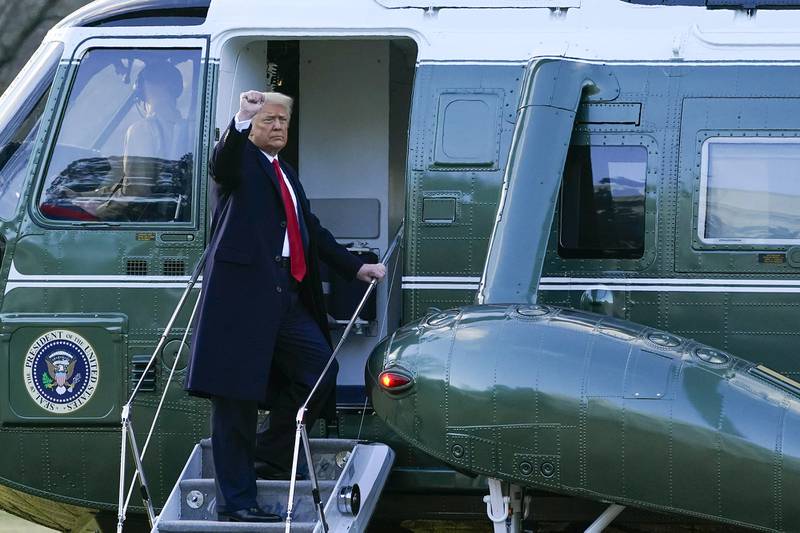 President Donald Trump gestures as he boards Marine One on the South Lawn of the White House, Wednesday, Jan. 20, 2021, in Washington. Trump is en route to his Mar-a-Lago Florida Resort.
