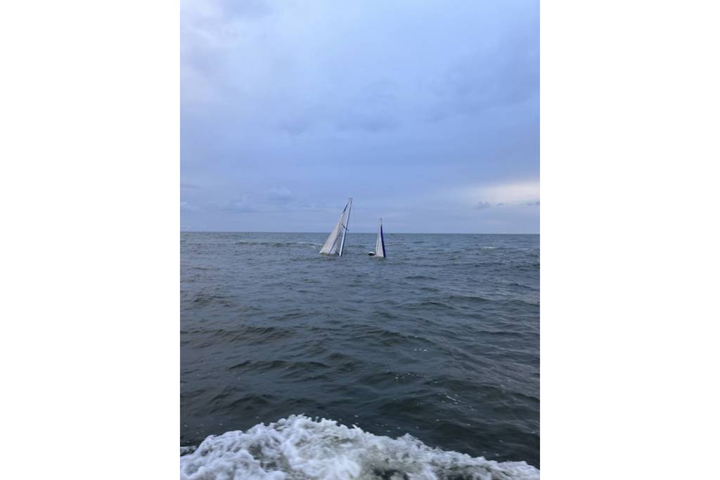 A Coast Guard Station Georgetown 45-foot response boat–medium crew rescues two people from the water after their 44-foot sailing vessel sank near the jetties by the entrance to Winyah Bay in Georgetown, South Carolina, Friday, Oct. 13, 2023.