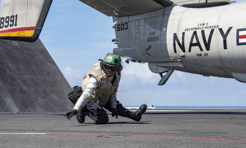 Aviation Machinist’s Mate 3rd Class Brandee Robinson conducts final checks on an E-2D Hawkeye as it prepares to launch from the flight deck of the aircraft carrier USS Ronald Reagan (CVN 76) on Aug. 2, 2020, in the Pacific Ocean.