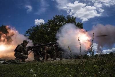 Ukrainian servicemen shoot a SPG-9 recoilless gun during training in Kharkiv region, Ukraine, Tuesday, July 19, 2022. (AP Photo/Evgeniy Maloletka)