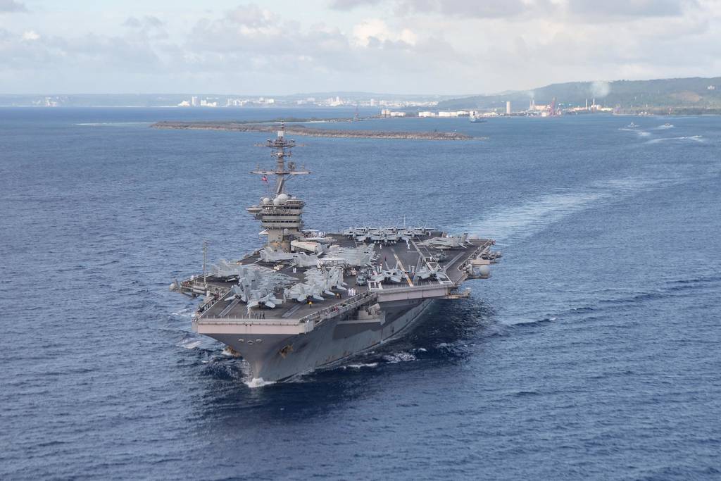 The aircraft carrier USS Theodore Roosevelt (CVN 71) departs Guam's Apra Harbor on June 4, 2020.