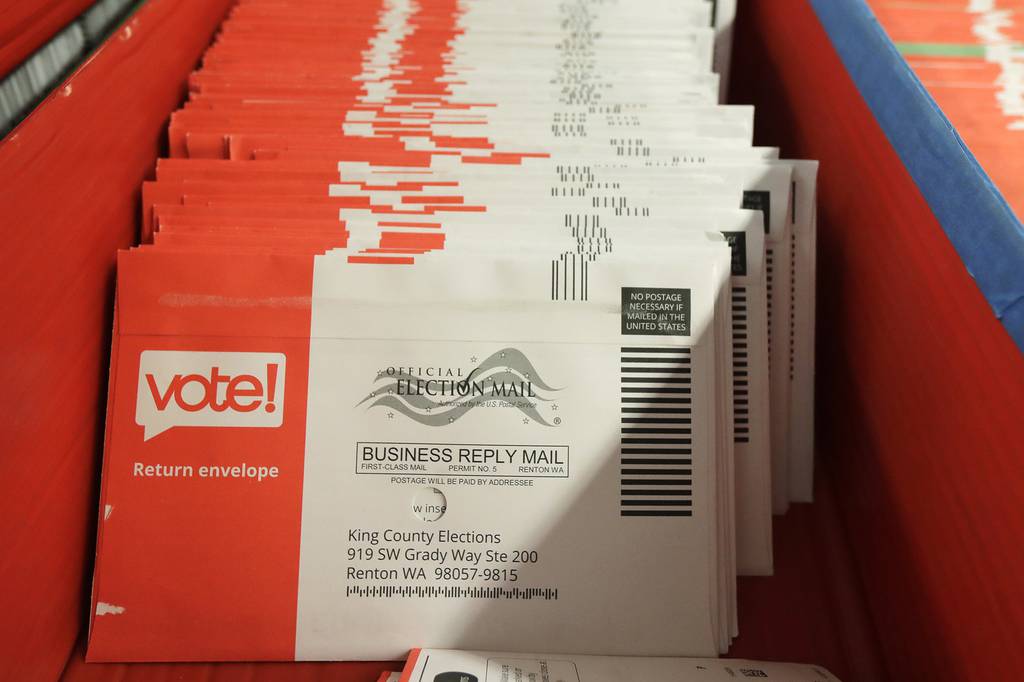 Vote-by-mail ballots are shown in a sorting tray on Aug. 5, 2020, at the King County Elections headquarters in Renton, Wash., south of Seattle.