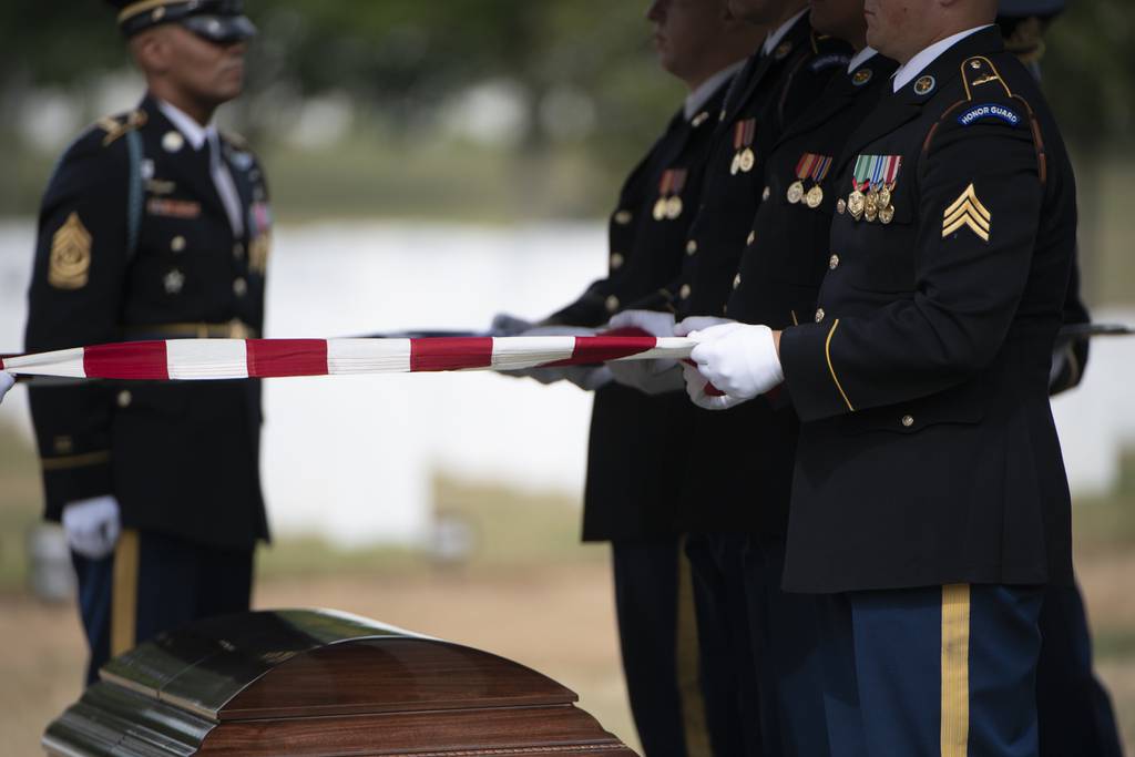 Soldiers from the 3d U.S. Infantry Regiment (The Old Guard) help conduct military funeral honors with funeral escort for a soldier killed during the Korean War in Section 55 of Arlington National Cemetery, Arlington, Virginia, Aug. 5, 2019.