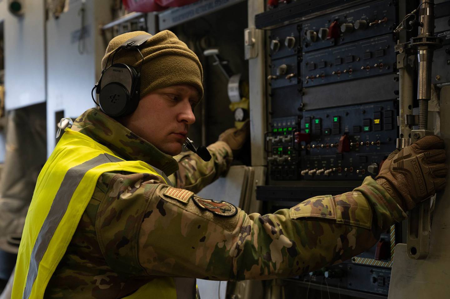 A U.S. Air Force airman assigned to the 435th Contingency Response Group waits for further instruction on a C-17 Globemaster III assigned to the 62nd Airlift Wing from Joint Base Lewis-McChord, Washington, in Rzeszów-Jasionka Airport, Poland, Feb. 8, 2022. Approximately 150 personnel from the 435th Air Ground Operations Wing deployed to support NATO allies and partners, specializing in combat communications, air traffic control, cargo transportation and airfield management. (Senior Airman Taylor Slater/Air Force)