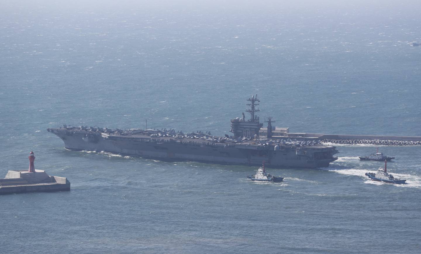 The U.S. Navy's nuclear-powered aircraft carrier USS Nimitz departs a naval base in Busan, South Korea, Sunday, April 2, 2023.