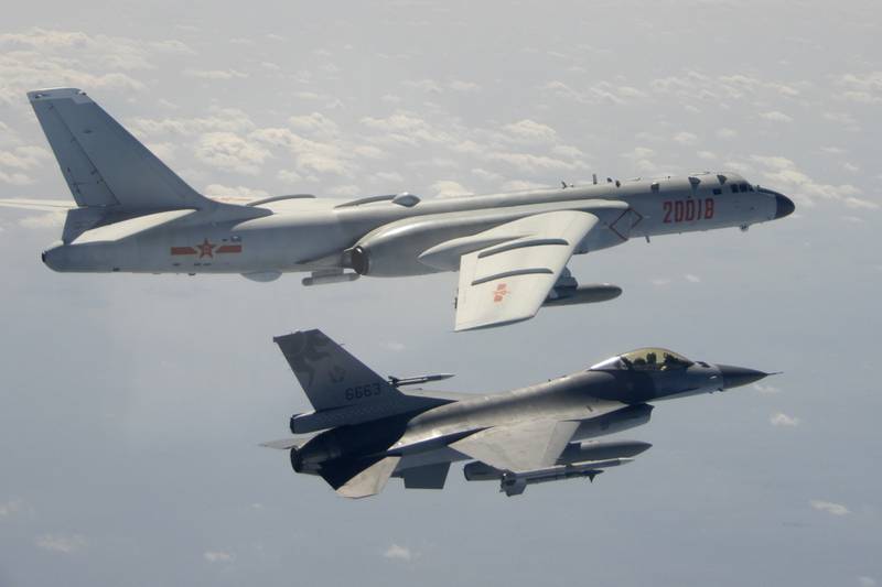 In this photo taken Feb. 10, 2020, and released by the Republic of China (ROC) Ministry of National Defense, a Taiwanese Air Force F-16 in foreground flies on the flank of a Chinese People's Liberation Army Air Force (PLAAF) H-6 bomber as it passes near Taiwan.