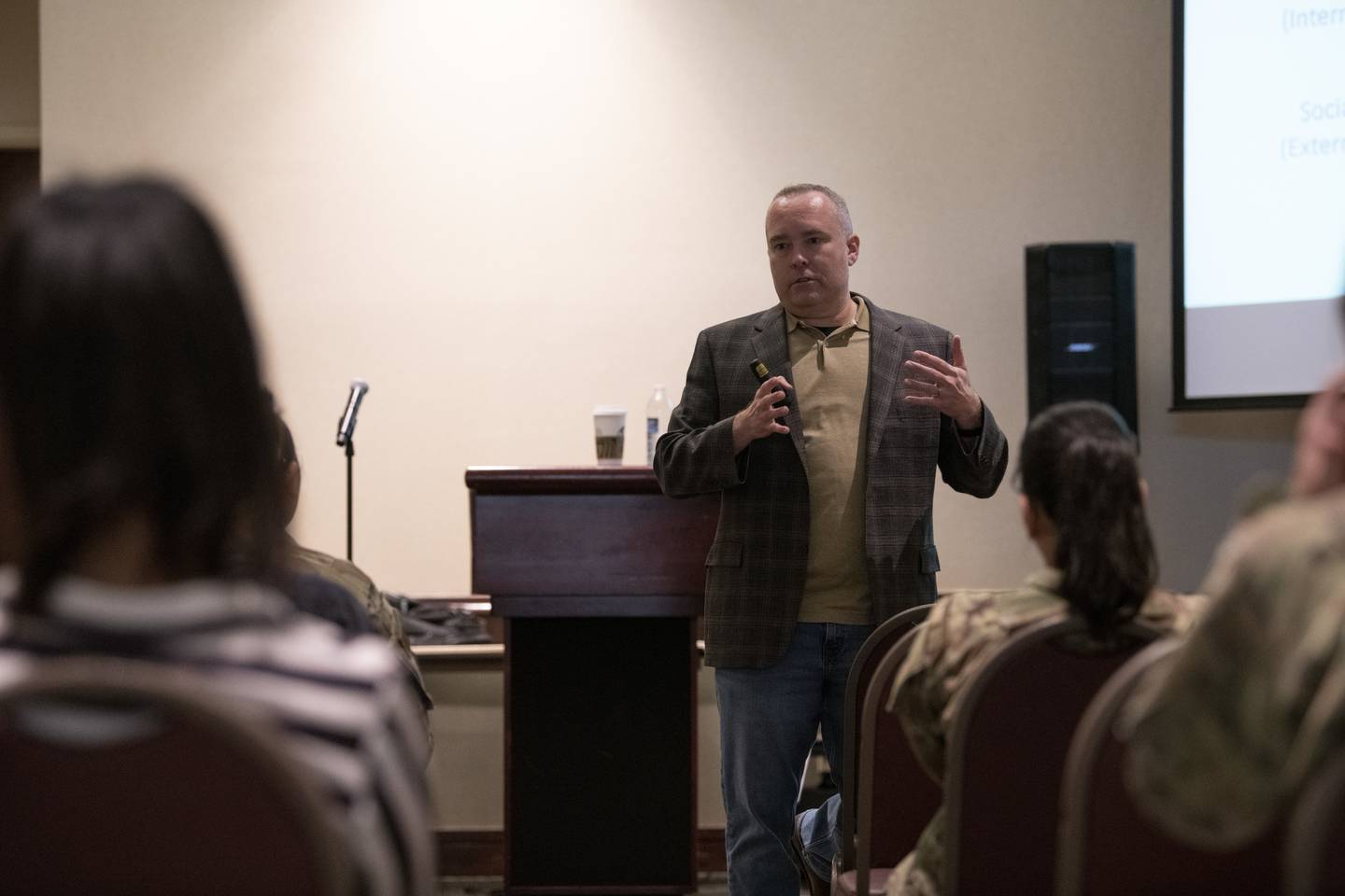 Psychologist Craig Bryan speaks to a room of David Grant USAF Medical Center mental health care providers at Travis Air Force Base, California, in 2022.