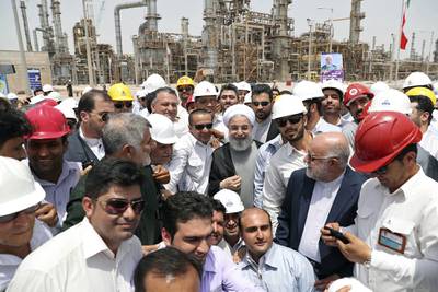 In this April 30, 2017, file photo, released by an official website of the office of the Iranian Presidency, Iranian President Hassan Rouhani, center, inaugurates the Persian Gulf Star Refinery in Bandar Abbas, Iran.