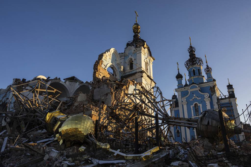 A cupola lies on the ground in front of the Orthodox Church which was destroyed by Russian forces in the recently retaken village of Bogorodychne, Ukraine, Saturday, Jan. 7, 2022.