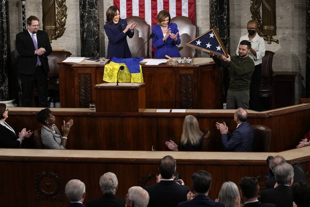 Vice President Kamala Harris and House Speaker Nancy Pelosi of Calif., applaud as Ukrainian President Volodymyr Zelenskyy holds an American flag that was gifted to him by Pelosi after he addressed a joint meeting of Congress on Capitol Hill in Washington, Wednesday, Dec. 21, 2022.