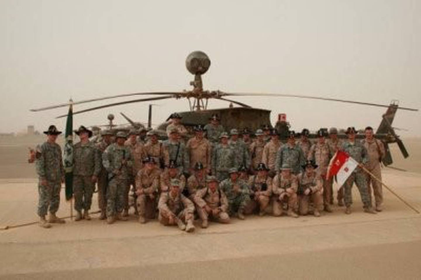 B 3-17 CAV, 10th Mountain Division, stand in front of an OH-58D the day before they fly into Baghdad, Iraq during the 2008 surge.