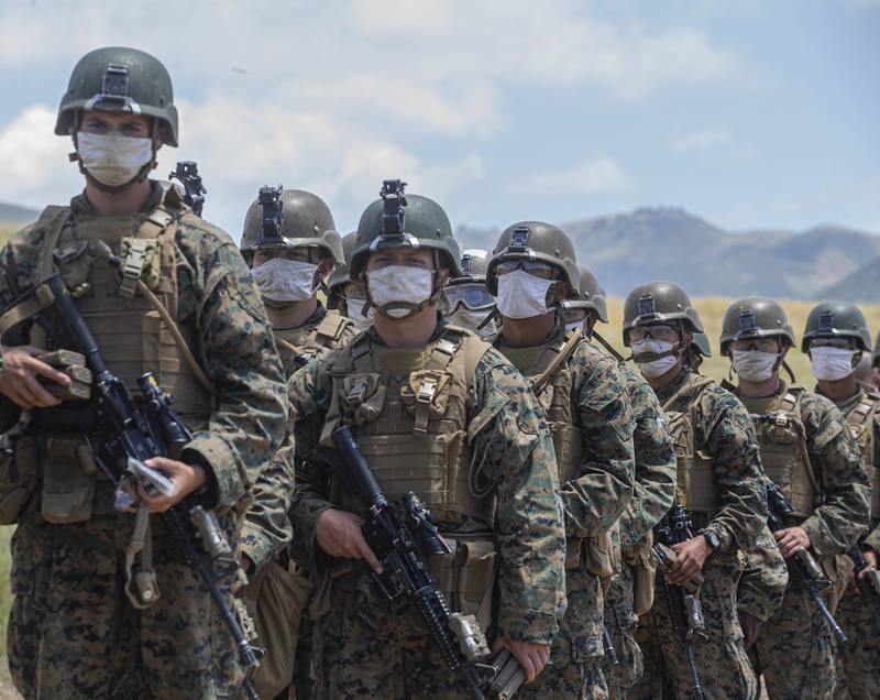 Marines with Alpha Company, Infantry Training Battalion, School of Infantry - West, wait to be lined out after live-fire training on Range 210F on Marine Corps Base Camp Pendleton, Calif.
