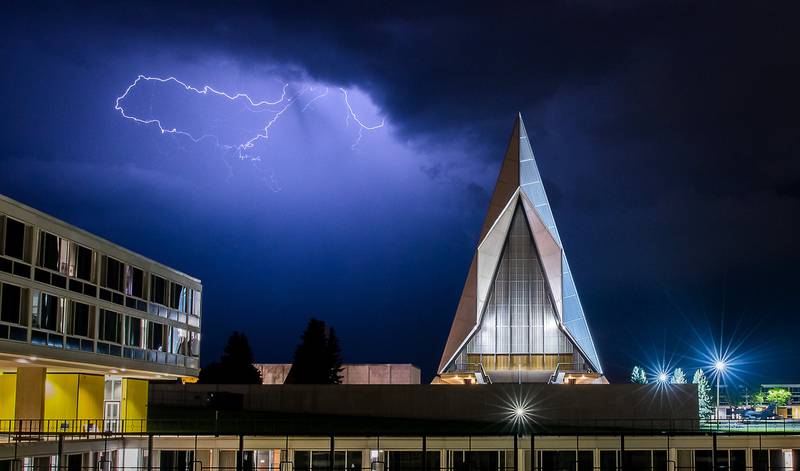 A late evening thunderstorm on Aug. 2, 2019, lights up the sky above the Cadet Chapel at the U.S. Air Force Academy, Colo.