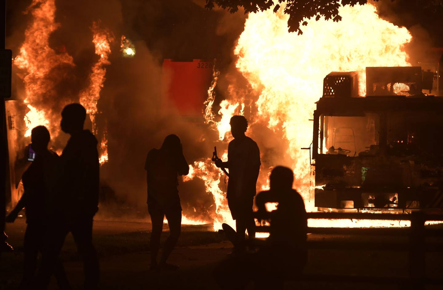 Garbage and dump trucks were set ablaze on Sunday, Aug. 23, 2020 by rioters near the Kenosha County Courthouse where they had been set up to prevent damage to the building.