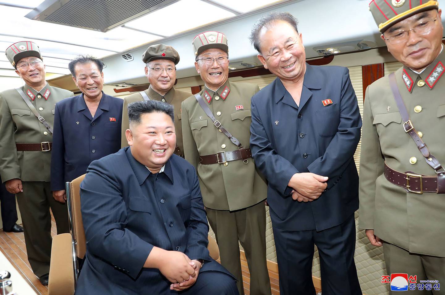 In this Saturday, Aug. 10, 2019, photo provided by the North Korean government, North Korean leader Kim Jong Un, sitting, watches test firings of short-range weapons at an undisclosed location in North Korea.