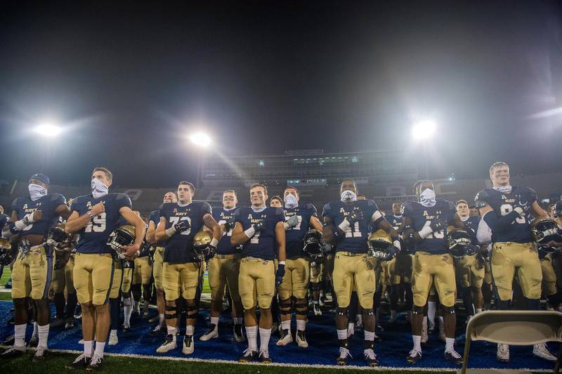 U.S. Naval Academy players sing "Navy Blue and Gold," their alma mater song on Oct. 3, 2020, following the Navy vs. Air Force football game in Falcon Stadium at the U.S. Air Force Academy.