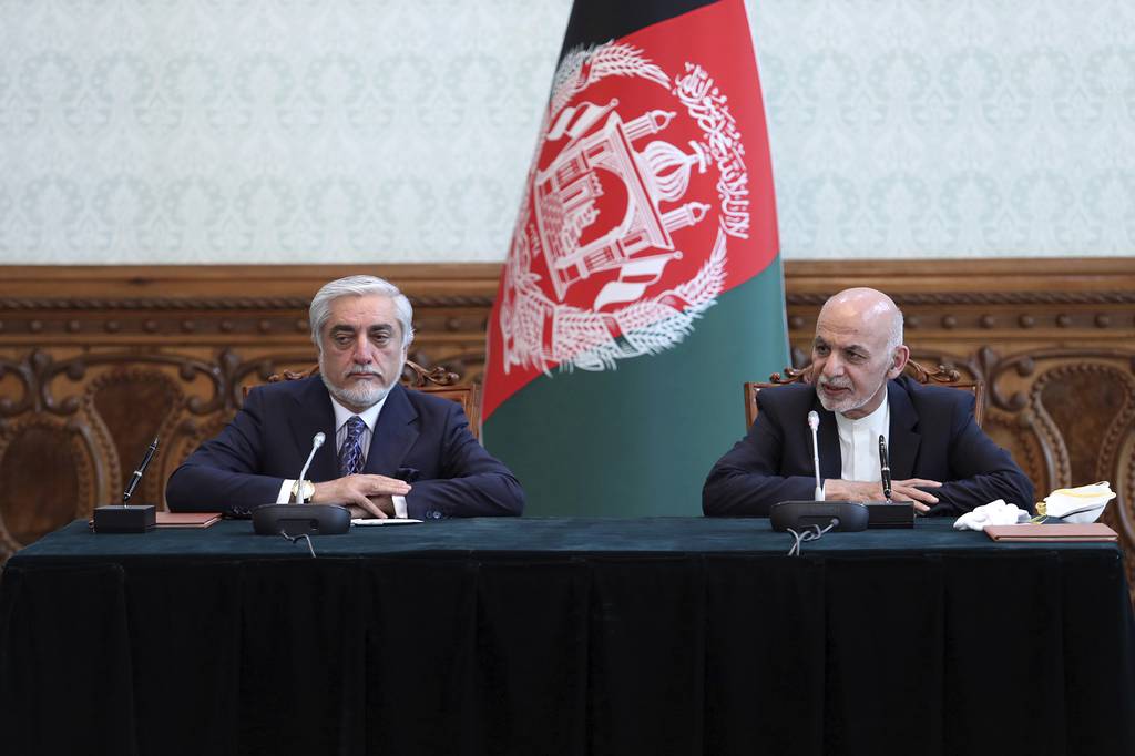 Afghan President Ashraf Ghani, right, and political rival Abdullah Abdullah, speak after they signed a power-sharing agreement at the presidential palace in Kabul, Afghanistan, Sunday, May 17, 2020.