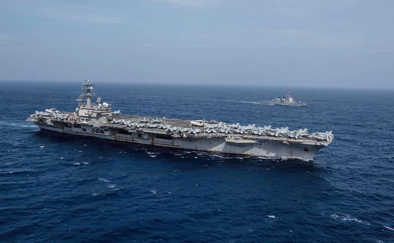 The Navy's forward-deployed aircraft carrier USS Ronald Reagan (CVN 76) sails alongside the Japan Maritime Self-Defense Force (JMSDF) guided-missile destroyer JS Myoko (DDG-175) on Aug. 15, 2019, while underway in the Philippine Sea.