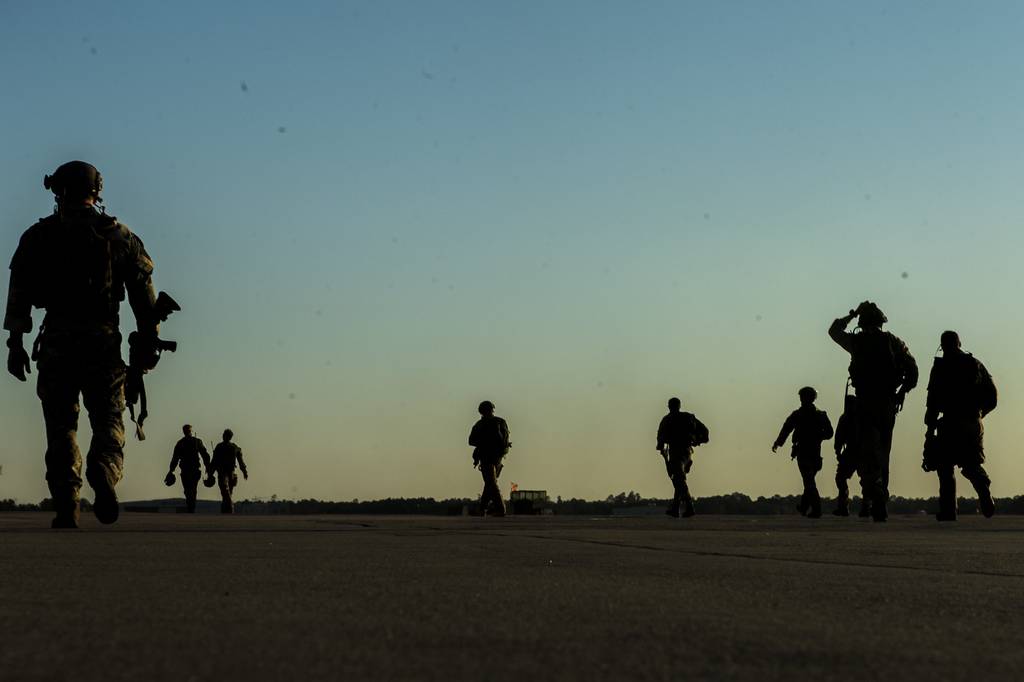 U.S. soldiers with the 20th Special Forces Group walk on a flight line in Gulfport, Miss., May 5, 2014, during Emerald Warrior 2014, a U.S. Special Operations Command-sponsored exercise designed to provide realistic military training in an urban setting.
