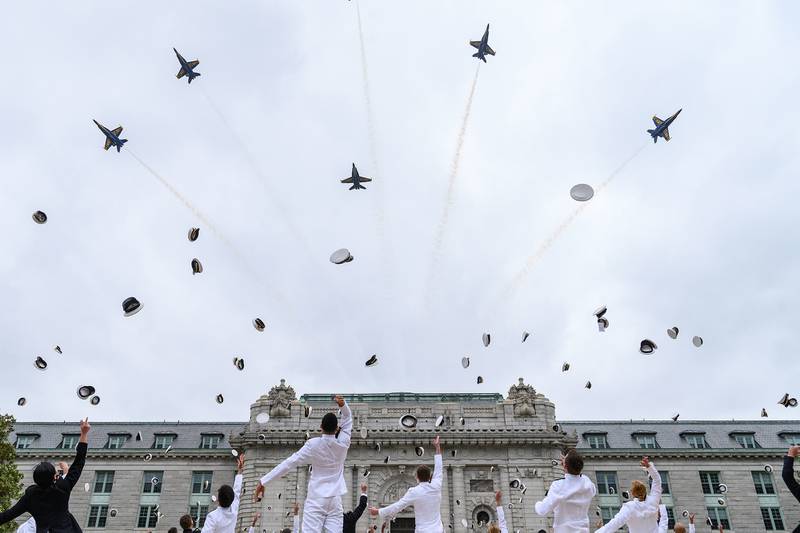 The U.S. Navy Flight Demonstration Squadron, the Blue Angels, fly over Bancroft Hall as midshipmen toss their covers concluding the fifth swearing-in event for the United States Naval Academy Class of 2020 on May 20 in Annapolis, Md.