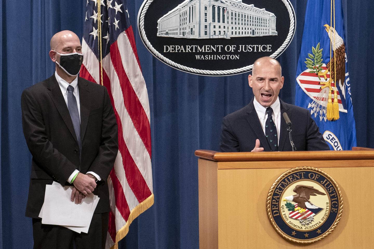Steven D'Antuono, head of the FBI Washington field office, left, listens as acting U.S. Attorney Michael Sherwin, speaks during a news conference Tuesday, Jan. 12, 2021, in Washington.