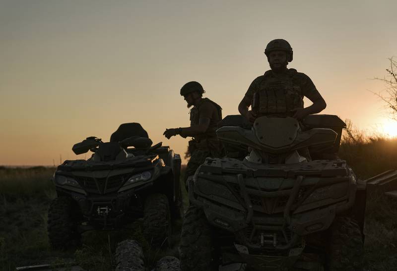 Ukrainian soldiers ride all-terrain vehicles at the front line near Bakhmut, one of the longest battles with Russian troops, Ukraine, Monday, Aug. 14, 2023.