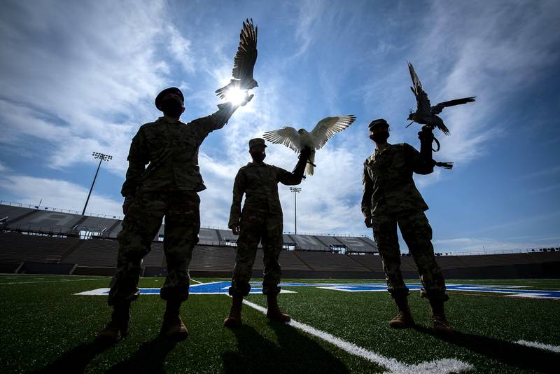 Cadet 2nd Class Kayla Steiner, center, handler of Nova, the newly named 15-week-old full white-phase Gyrfalcon, displays the new mascot of the U.S. Air Force Academy with Cadet 1st Class Seamus Kean, left, and Cadet 3rd Class Sierra Hillard, right.