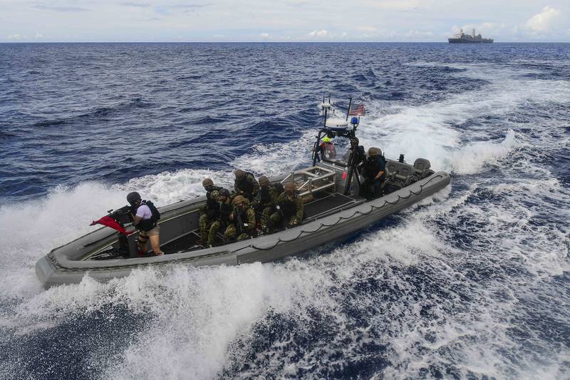 A visit, board, search and seizure team from the amphibious transport dock ship USS New Orleans (LPD 18) approaches a simulated suspect vessel during a training exercise Sept. 16, 2020, in the Philippine Sea.
