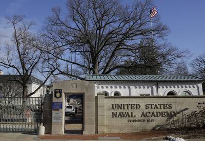 A sign stands outside of an entrance to the U.S. Naval Academy campus in Annapolis, Md., on Jan. 9,2014.
