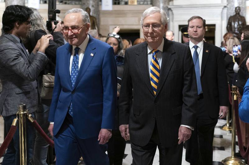 Chuck Schumer, DN.Y.  Senate Majority Leader, accompanied by Senate Minority Leader Mitch McConnell, President Joe Biden arrives for the State of the Union address to a joint session of Congress at the Capitol, Tuesday, Feb.  7, 2023, in Washington.