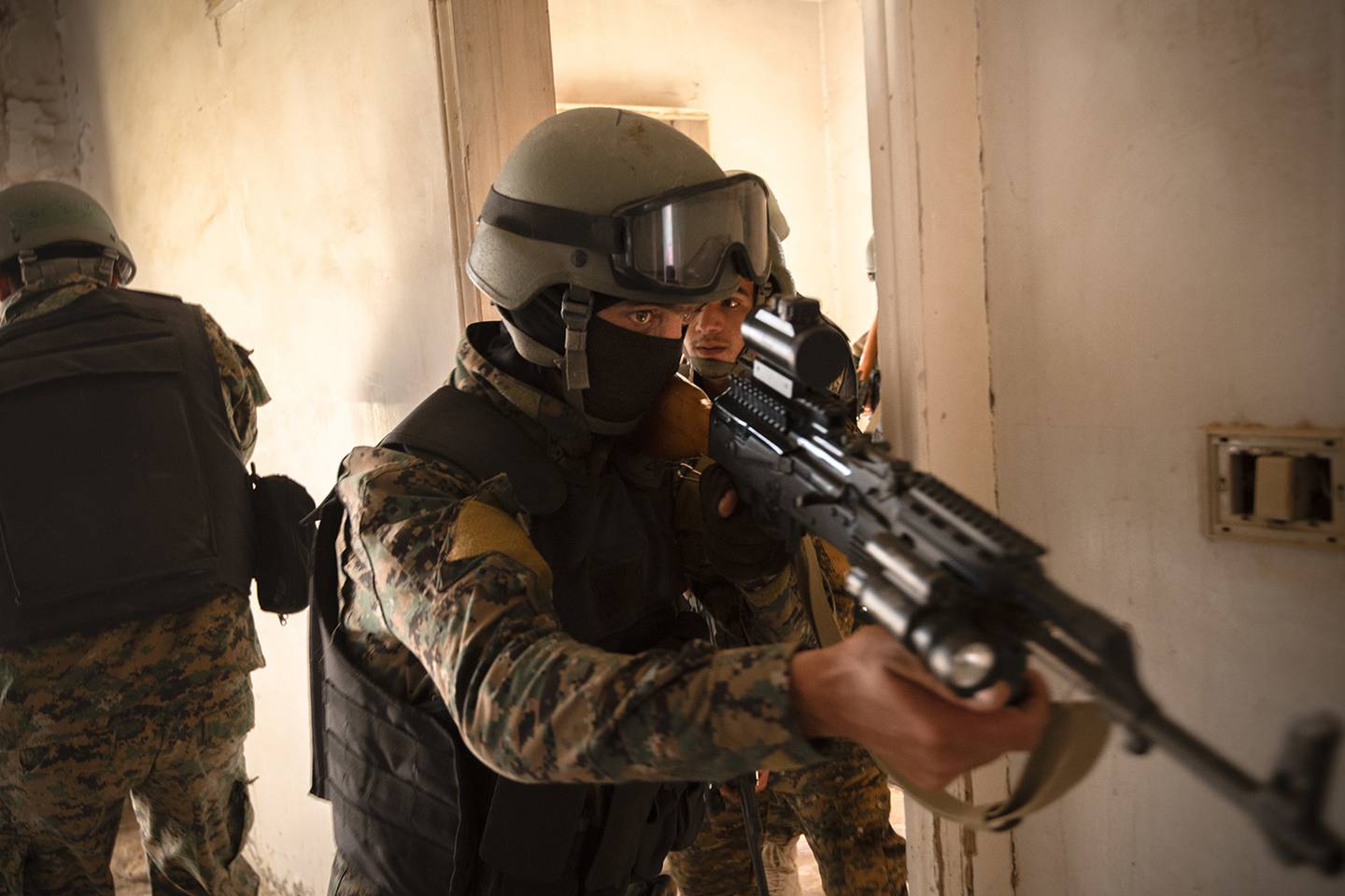 Syrian Democratic Force commando cadets clear a room during military operations in urban terrain training in Syria, Aug. 3, 2019.
