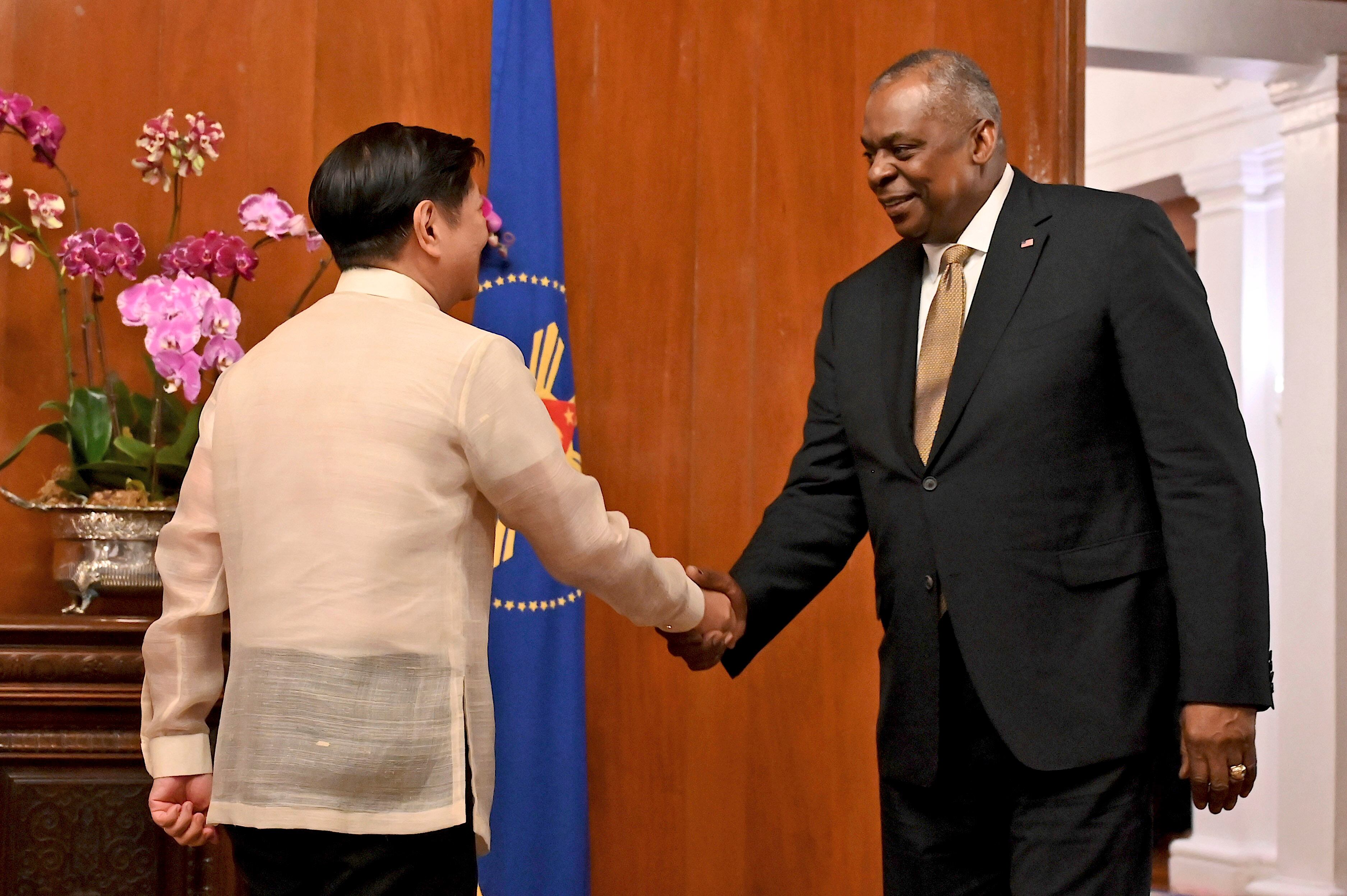 U.S. Secretary of Defense Lloyd James Austin III, right, shake hands with Philippine President Ferdinand Marcos Jr. during a courtesy call at the Malacanang Palace in Manila, Philippines on Thursday, Feb. 2, 2023.